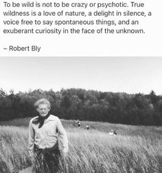 a man standing in the middle of a field next to a quote from robert bly