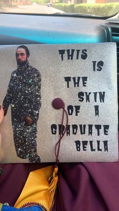 this is the sign for graduate bell, which has been placed on a car's dashboard