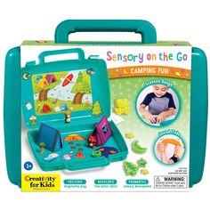 a blue suitcase with an open lid and pictures on the front, inside it is a child's play set