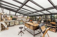 an office with lots of shelves and desks in the middle of it's room