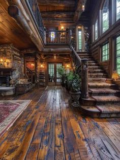 the inside of a log cabin with wood floors and stairs