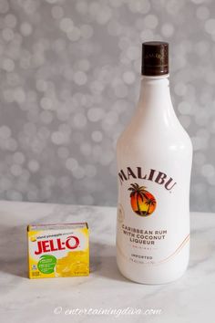 a bottle of jello next to a carton of marlbu on a table