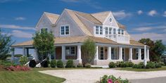 a large white house sitting on top of a lush green field