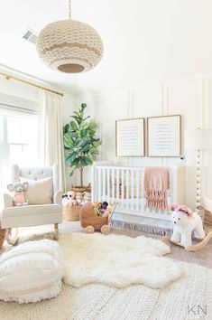 a baby's room with white furniture and decor