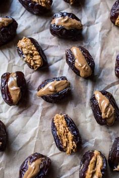 dates with peanut butter and walnuts on waxed parchment paper, ready to be eaten