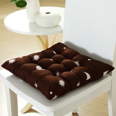 a brown and white chair cushion sitting on top of a table