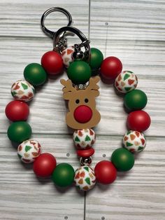 a christmas ornament keychain with a reindeer head on it's side