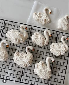 frosted swan cookies on a cooling rack