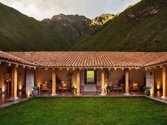 an outdoor patio with mountains in the background and grass on the ground to the side