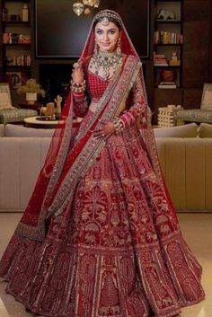 a woman in a red and gold bridal gown