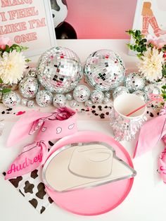 a table topped with pink and silver decorations