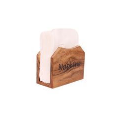 the napkin holder is made out of wood and has a white napkin on top of it