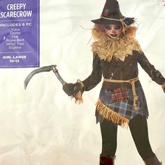 a creepy scarecrow holding a knife and wearing a hat