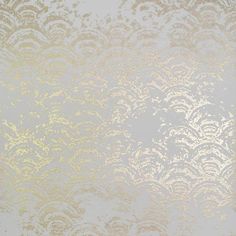 a white and gold wallpaper with an intricate design on it's surface,