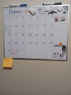 a calendar with stickers on it hanging on the wall