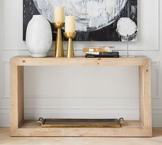 a console table with two candles on it