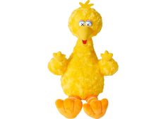 a yellow stuffed animal with big eyes and arms, sitting on the ground in front of a white background