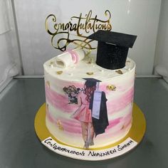 a decorated cake with a graduate's cap and gown on top