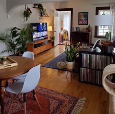 a living room filled with furniture and a flat screen tv sitting on top of a wooden table