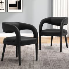 two black chairs sitting on top of a carpeted floor