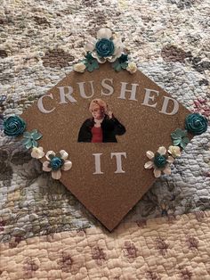 a graduation cap with a photo on it and flowers around the edges that says, crushed it