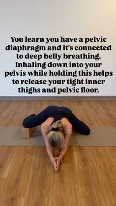 a woman is doing yoga on the floor with her head in her hands and arms behind her back