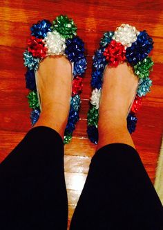 a pair of feet wearing red, white, and blue flowers on them's toes