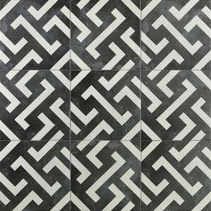 a black and white tile design with an intertwined pattern in the center, on a wall