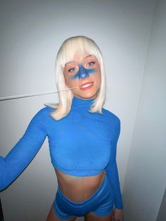 a woman with white hair and blue makeup