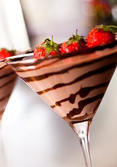 two glasses filled with chocolate and strawberries