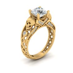 a yellow gold engagement ring with an intricate design and a center stone surrounded by diamonds