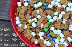 a red bowl filled with marshmallows and m & ms movie night snack mix