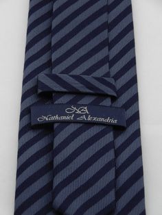 "Mens navy on blue silk striped necktie, perfect for weddings, work or everyday use. Available as a extra long tie Handmade from 100% silk, this special collection features a .75\" Eds Neckties logo at the bottom right front corner of every tie and a larger logo located on the tipping (Back of the tie). The label features the collection name (Nathaniel Alexandria) Named after my son Nathaniel and my daughter Alexandria. Expertly hand-made from 100% silk you can select your length from 57\" to 65 Tie Men's, Striped Tie, Blue Silk, Mens Navy, Necktie, My Son, My Daughter, Extra Long, The Label