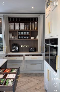 a kitchen with gray cabinets and white counter tops, an open drawer in the middle