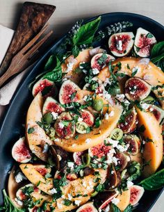 a platter filled with sliced figs and cheese