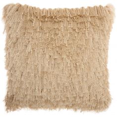 a beige pillow that is made out of fluffy fur and has fringes on it