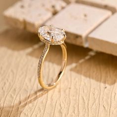 a diamond ring sitting on top of a wooden table