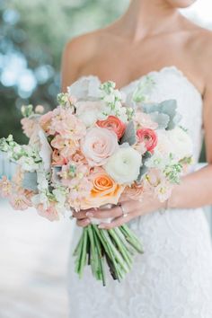 a woman holding a bouquet of flowers in her hands