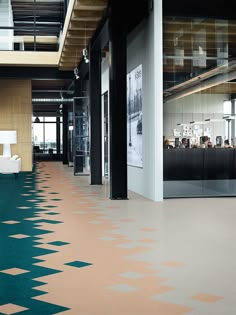 an office lobby with green and beige carpeting