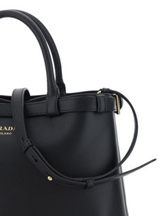 MEDIUM LEATHER HANDBAG FROM PRADA, TWO STIFF ROUND HANDLES, ADJUSTABLE HANDLE STOPS VIA BELT-STYLE BUCKLE, OPEN TOP END, DUAL SEPARATE COMPARTMENTS INSIDE, INTERIOR LOGO-PRINTED LINING, MATTE LEATHER FINISH, ICONIC TRIANGULAR ENAMELED SIGNATURE BRAND PLAQUE APPLIED TO FRONT, REMOVABLE AND ADJUSTABLE FLAT SHOULDER STRAP.UNIHeight: 25 cm, Length: 35 cm, Depth: 14 cmGender: WOMENMaterial: CALF LEATHER BOS TAURUSColor: BLACKMade in: IMPORTEDProduct ID: 1BA417VOOO2CYS_F0002*Import tax/duty will be ca Designer Business Bags With Removable Belt, Designer Business Bag With Removable Belt, Luxury Shoulder Bag With Removable Belt For Business, Luxury Business Shoulder Bag With Removable Belt, Classic Leather Bag With Removable Belt, Leather Evening Bag With Removable Belt, Elegant Leather Shoulder Bag With Belt Loops, Luxury Formal Shoulder Bag With Removable Belt, Designer Leather Bag With Belt Detail