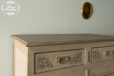 an old dresser with carvings on the drawers