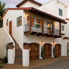 a large white house with lots of windows and balconies