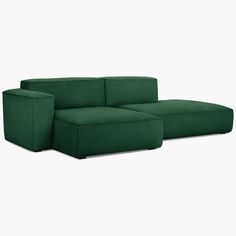 a green couch sitting on top of a white floor