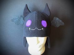 a black hat with purple eyes and bats on it