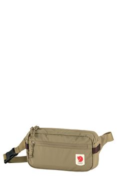 the waist bag is beige and has a red heart on it