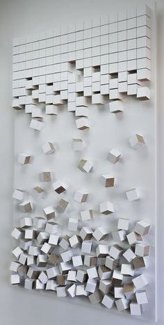 a white wall with lots of cubes on it