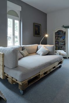 a couch made out of wooden pallets in a living room