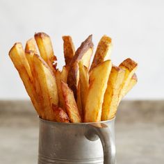 french fries in a metal cup on a table