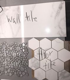 there are some white tiles with black writing on them and the words wall tile below it