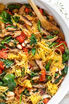 a white bowl filled with pasta and vegetables